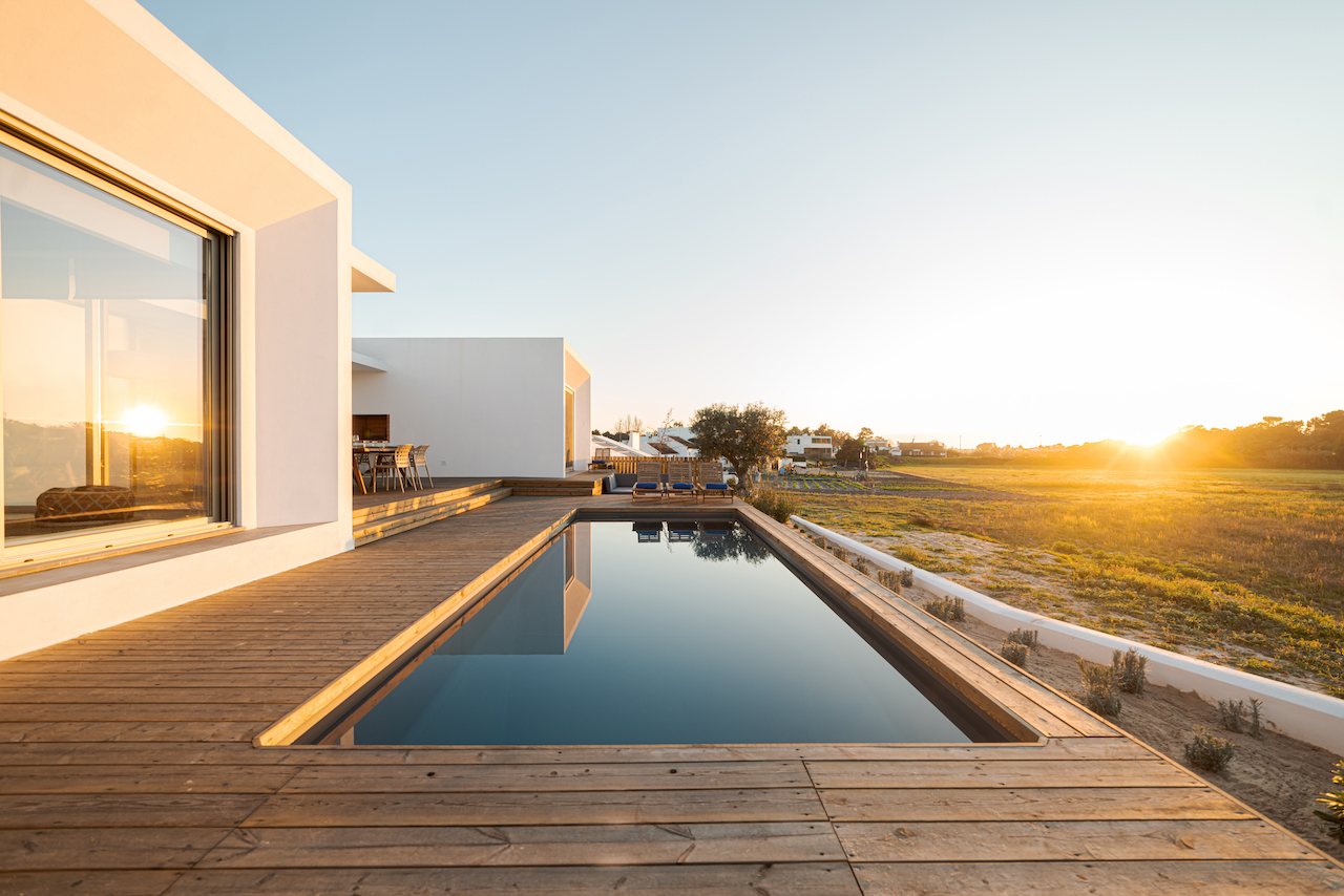 Swimming pool with wooden deck view on Modern villa